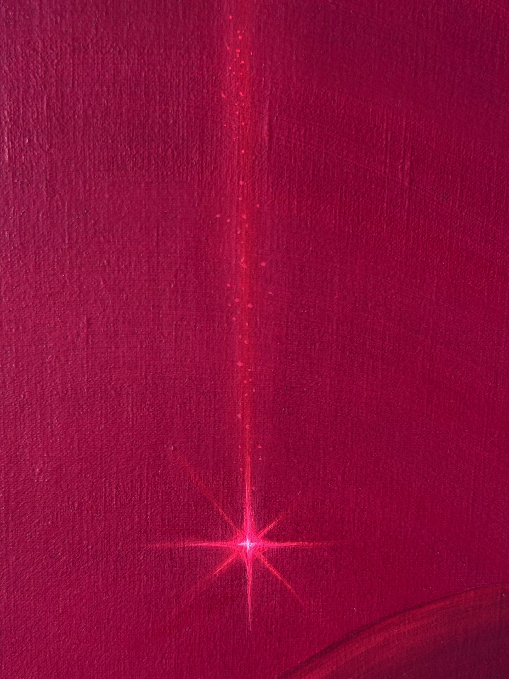 A close-up of a textured magenta-pink surface with a vertical bright pink streak running from the top center and a starburst-like highlight near the bottom center.
